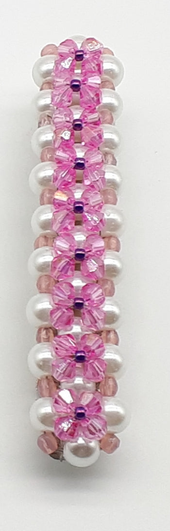 Pink  and purple beaded flower pattern hair barrette on a white pearl base