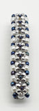 Silver and blue beaded flower pattern hair barrette on a white pearl base.