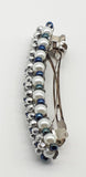 Silver and blue beaded flower pattern hair barrette on a white pearl base.