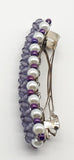 Purple beaded flower pattern hair barrette on a white pearl base.